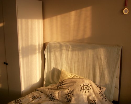 A cozy bedroom setting with soft warm lighting